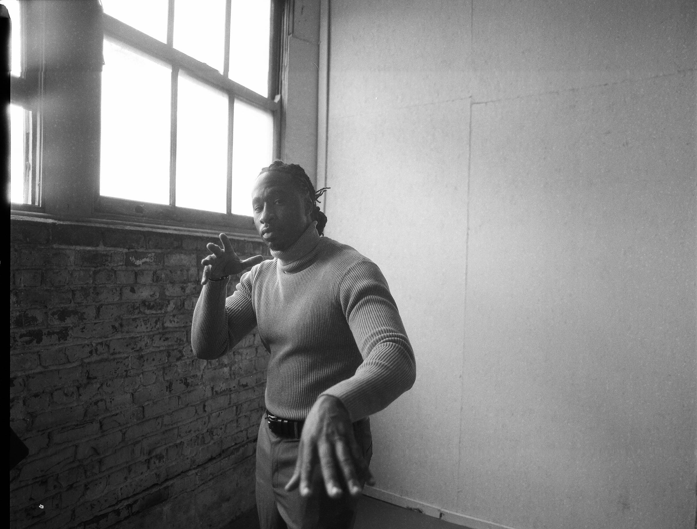Black and white 35mm film portrait, brick wall