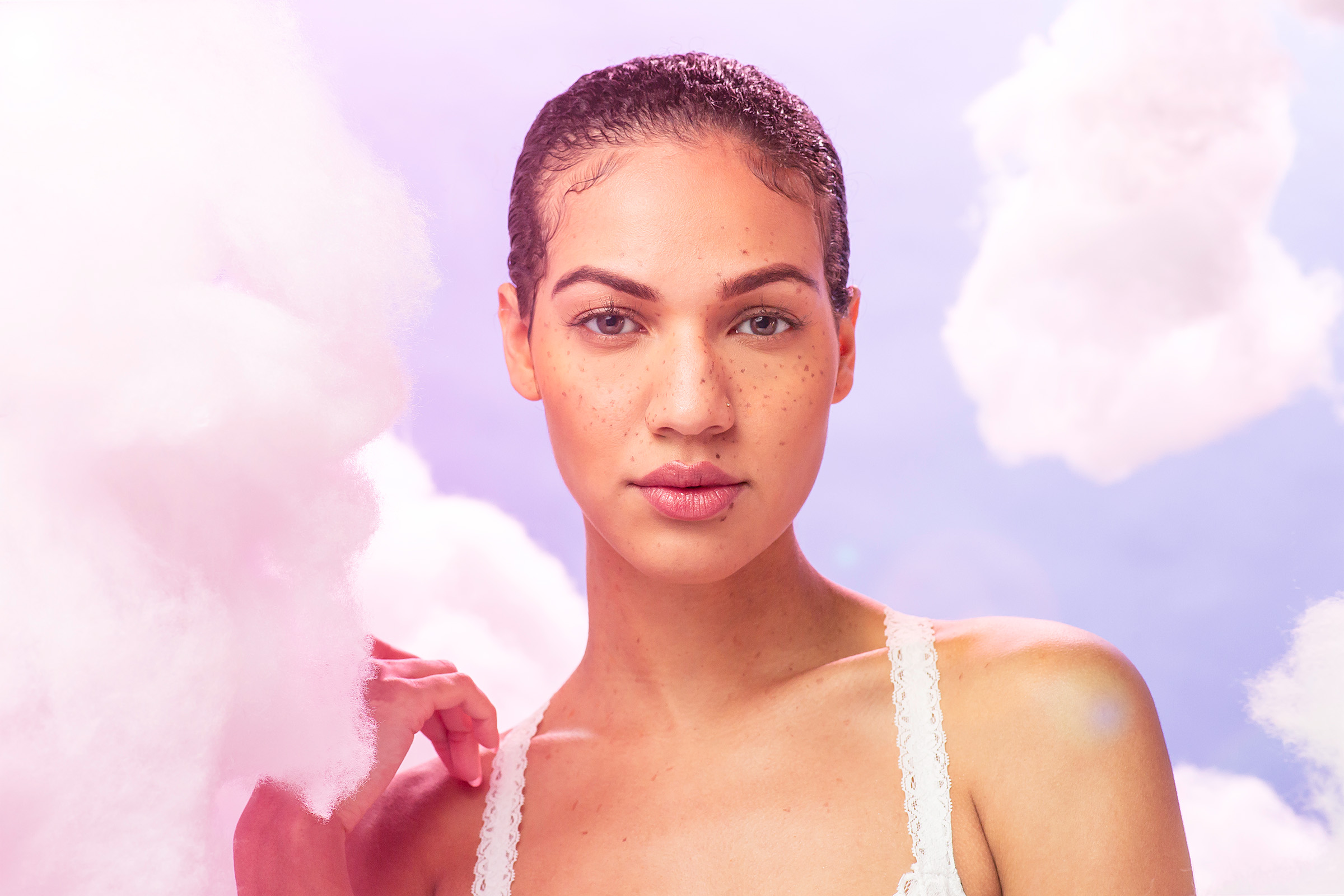 Ethereal portrait against cotton candy sky