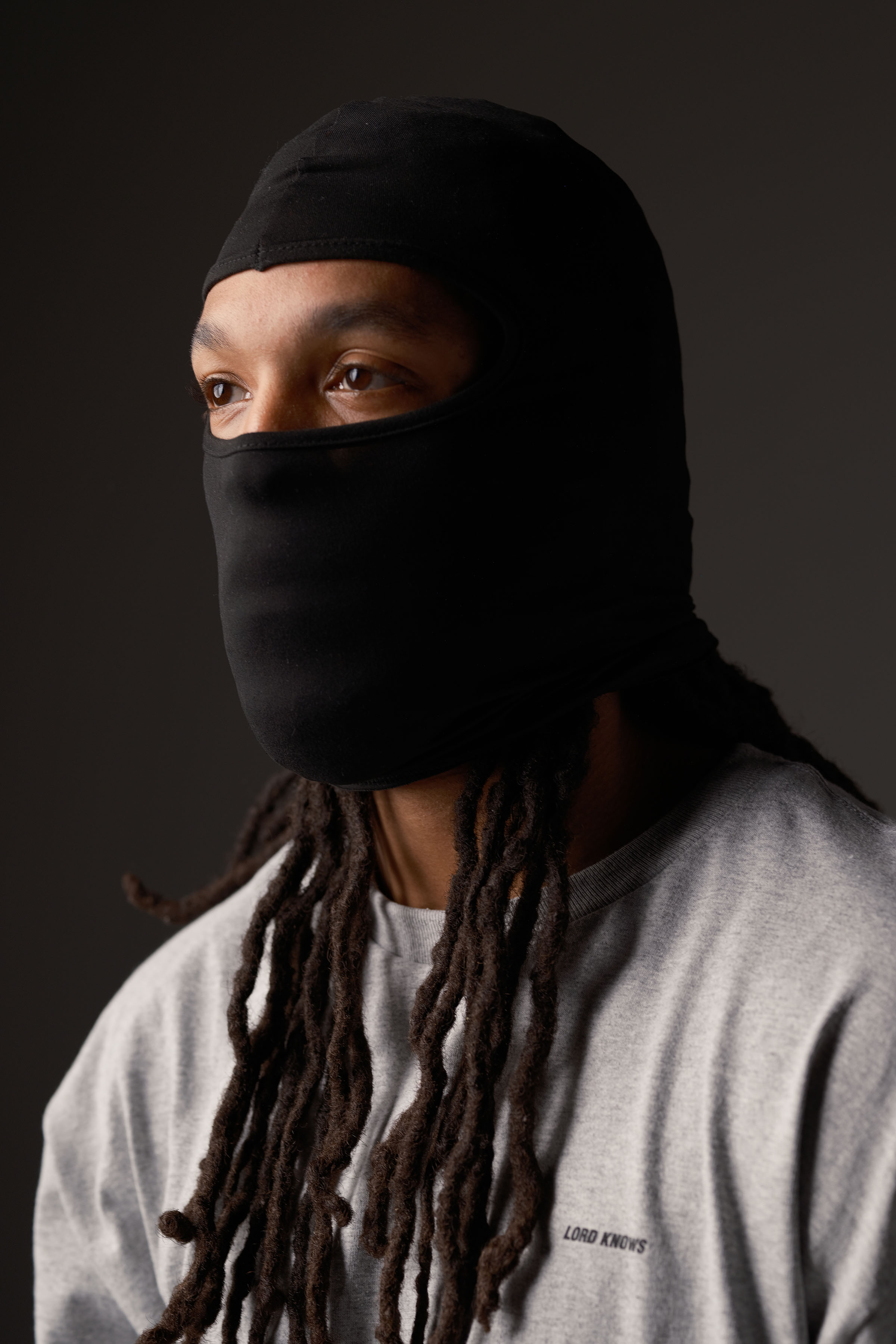 Portrait in black balaclava, dramatic studio lighting