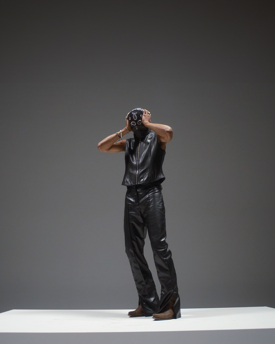 Full-length fashion portrait, leather vest and bandana