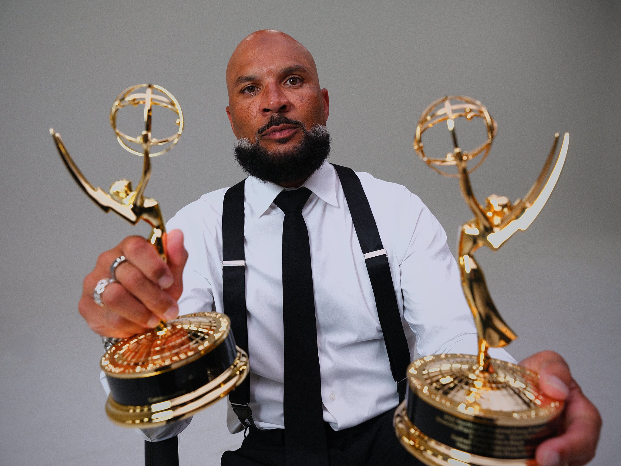 Rashad Floyd holding two Emmy statuettes