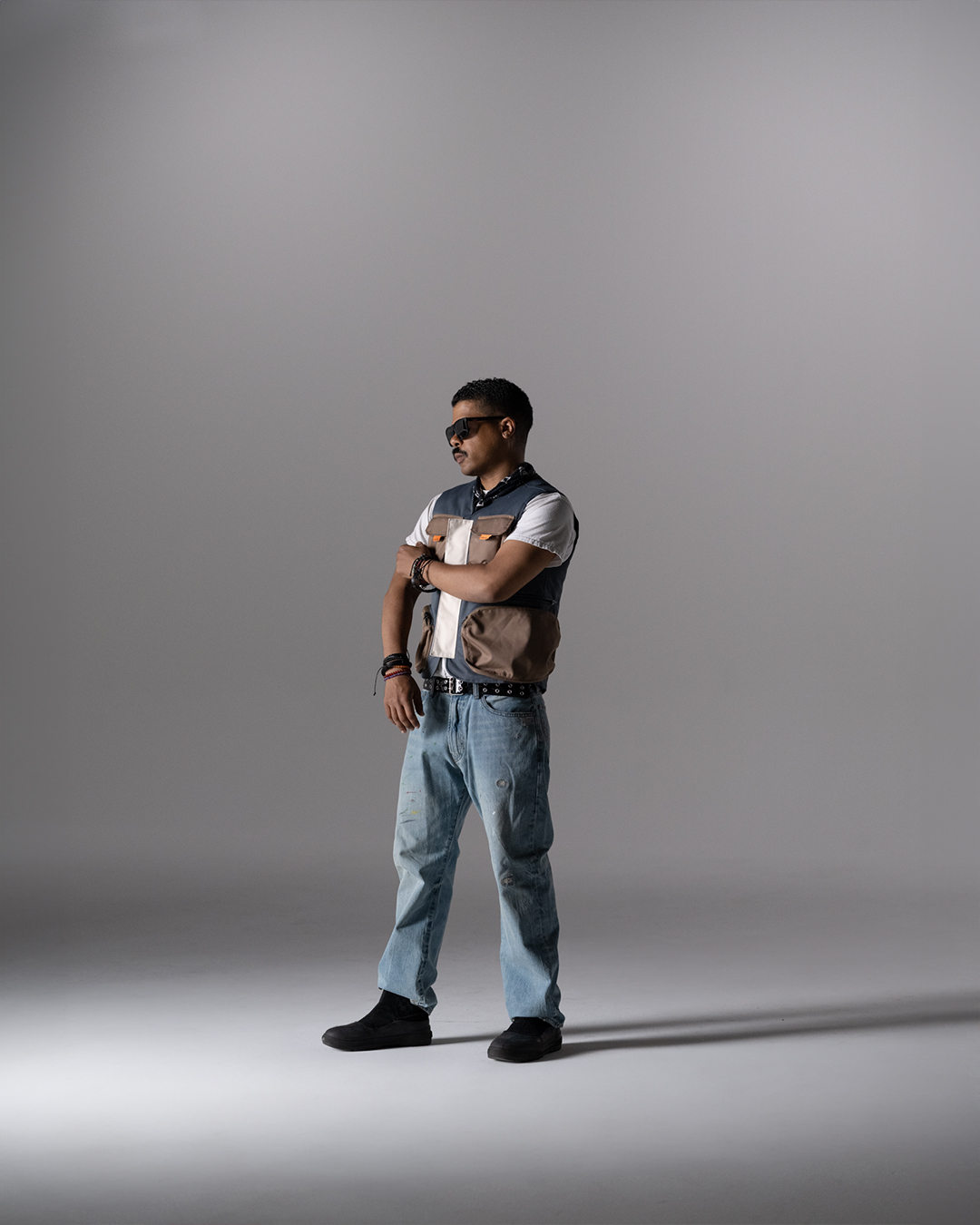 Full-length commercial portrait, utility vest and jeans