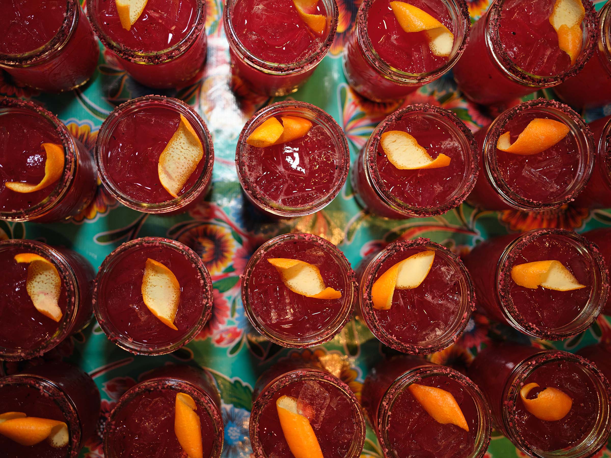 Cocktails in mason jars with citrus garnish