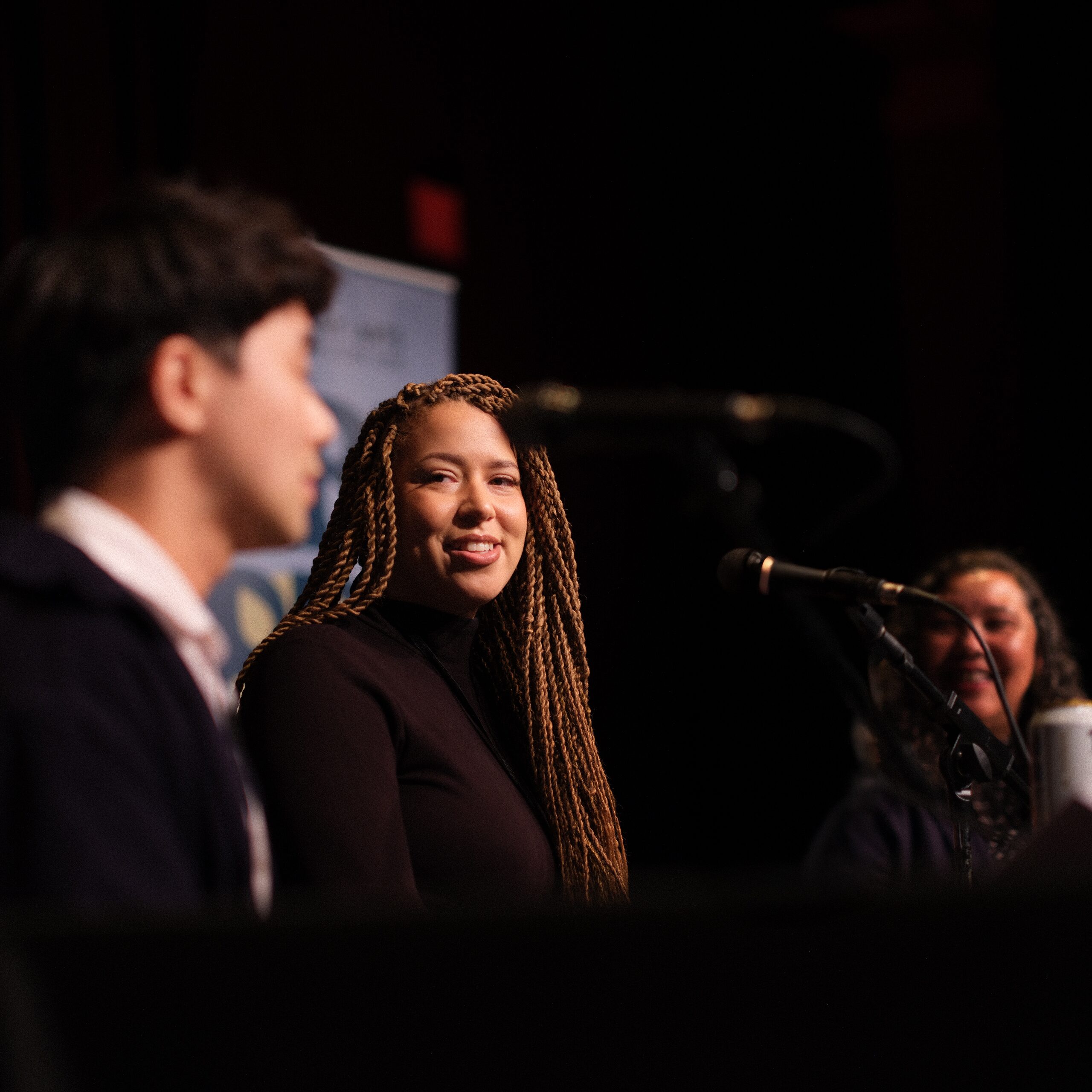 Authors in conversation at the microphone during a panel