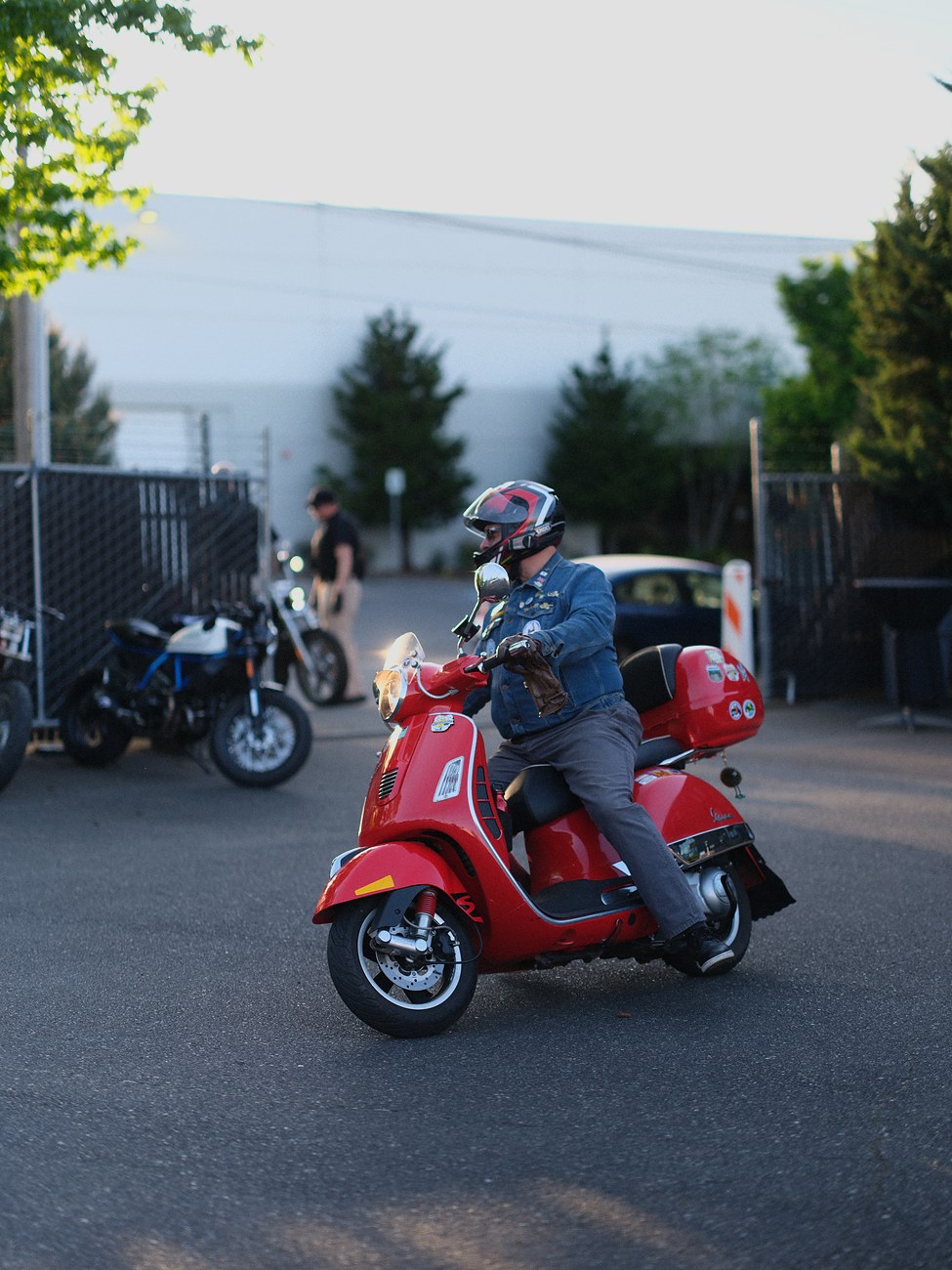Rider on a red Vespa scooter at the Honcho One Moto opening party