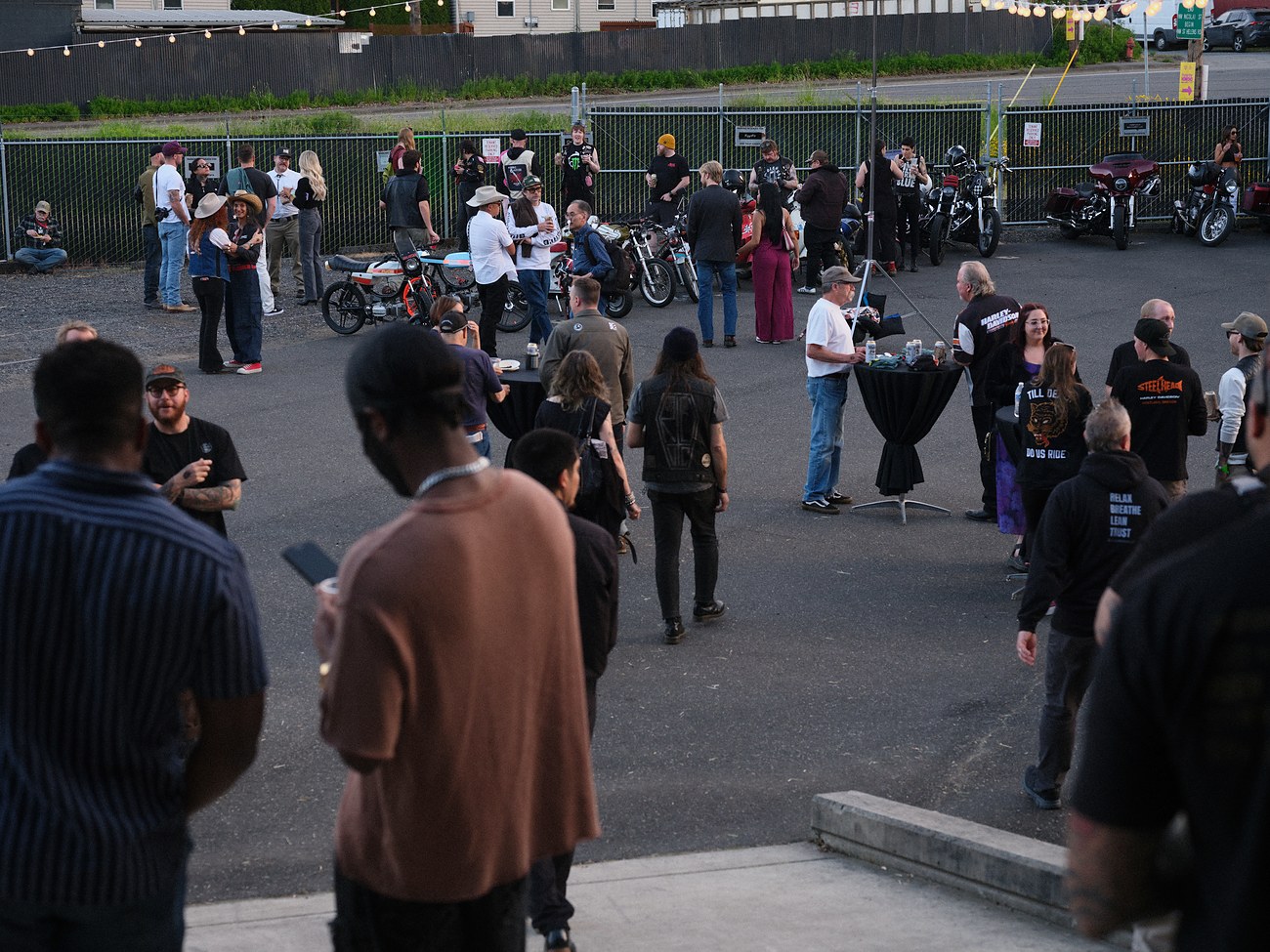 Crowd gathered among motorcycles at the Honcho party