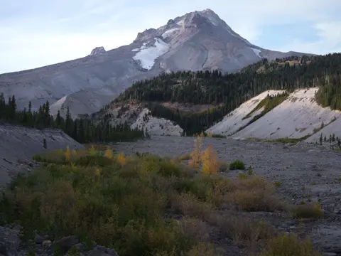 Mt. Hood above a glacial river valley with autumn brush in the foreground