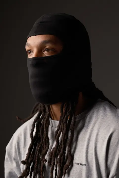 Portrait in black balaclava, dramatic studio lighting