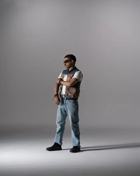 Full-length commercial portrait, utility vest and jeans