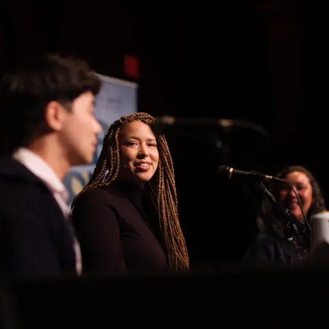 Authors in conversation at the microphone during a panel